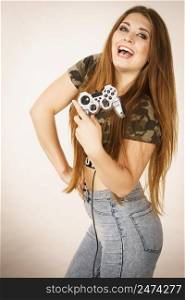 Young adult woman playing on the video console holding game pad. Gaming gamers concept.. Gamer woman holding gaming pad
