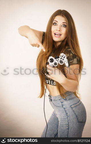 Young adult woman playing on the video console holding game pad. Gaming gamers concept.. Gamer woman holding gaming pad