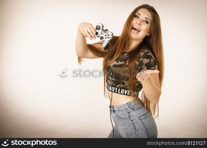 Young adult woman playing on the video console holding game pad. Gaming gamers concept.. Gamer woman holding gaming pad