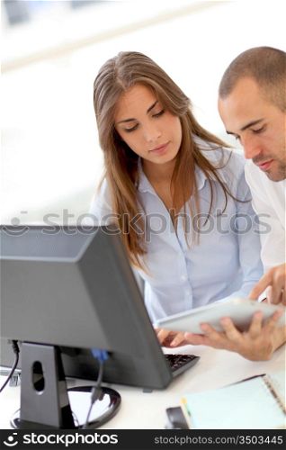 Young adults in training course using touchpad