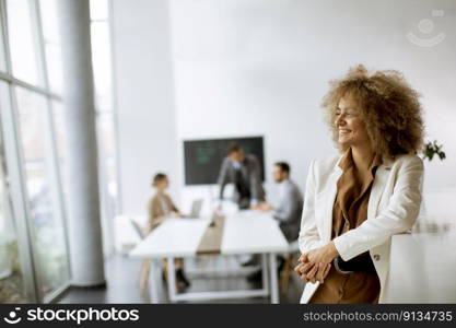 Young African American businesswoman standing in the modern office