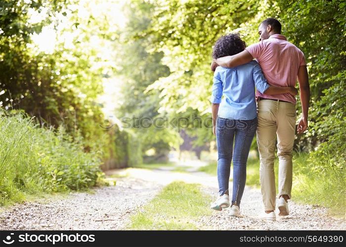 Young African American Couple Walking In Countryside