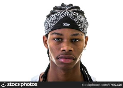 Young African-American man with do-rag on forehead looking at camera.. Young black man with do-rag