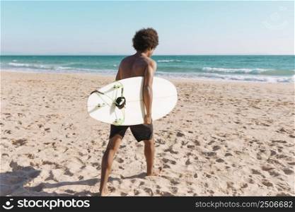 young african american man with surfboard beach
