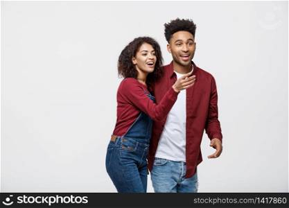 Young African American people in casual clothes looking away and point finger. isolated on white background.. Young African American people in casual clothes looking away and point finger. isolated on white background