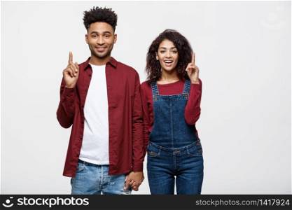 Young African American people in casual clothes looking away and point finger. isolated on white background.. Young African American people in casual clothes looking away and point finger. isolated on white background