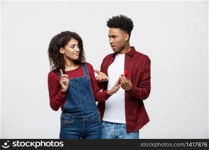 Young African American Scared girlfriend rejecting a marriage proposal. Humorous situation.. Young African American Scared girlfriend rejecting a marriage proposal. Humorous situation