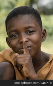 young african boy doing silent sign
