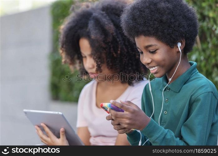Young African children using technology with be happy.