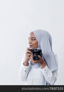 young  african modern muslim woman using retro camera wearing hijab clothes isolated on white background