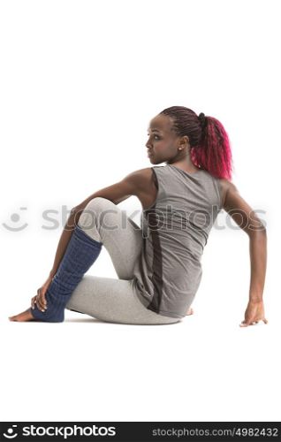 Young african woman doing a stretching exercise isolated on white background