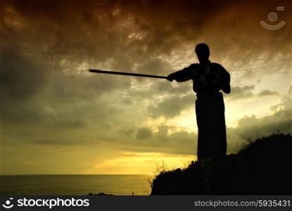 young aikido man fighter at sunset light