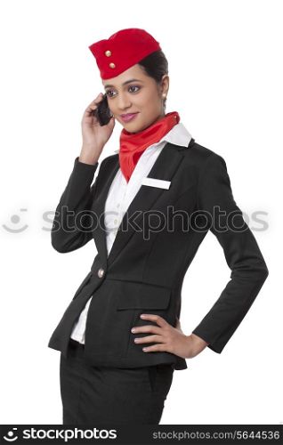 Young airhostess using cell phone isolated over white background