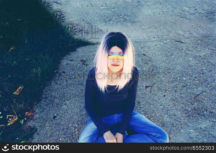 Young alternative woman with a rainbow in her face
