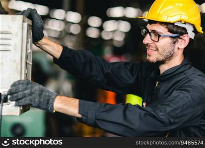 young American worker happy working to control machine,he enjoy smiling at heavy industrial factory.