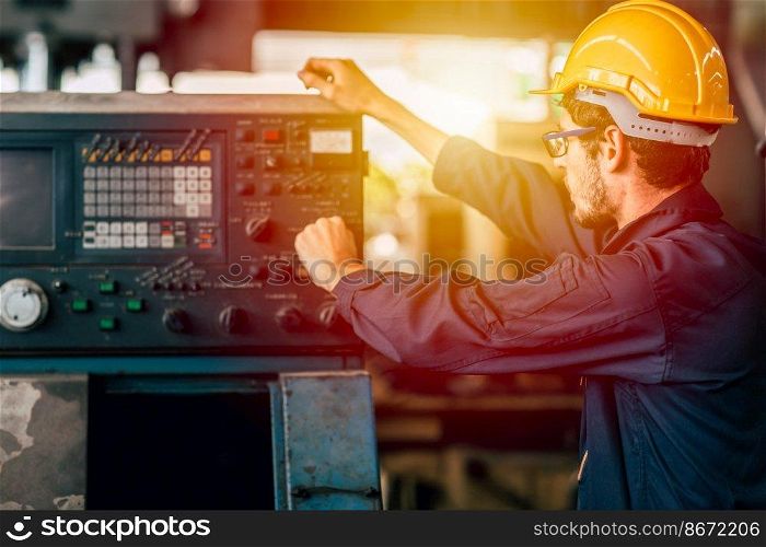Young American worker intend to work in a heavy industrial factory. Engineer operate the machine in facility.