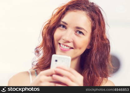 Young and attractive woman sitting in cafe and using cellphone. Texting massages at cafe