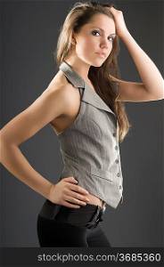 young and beautiful brunette with a waistcoat and a hand on head