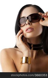 young and beautiful brunette with sunglasses and fashion accessories over white taking pose
