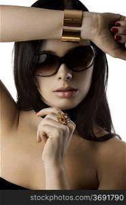 young and beautiful brunette with sunglasses red nails and fashion jewellery over white taking pose