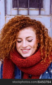 Young and beauty redhead woman wearing winter clothes