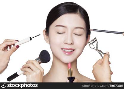 Young and elegant beauty making up