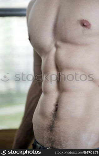 young and fit man exercise free mountain climbing on indoor practice wall