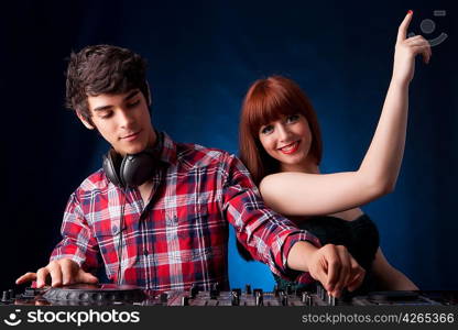 Young and handsome dj playing some music