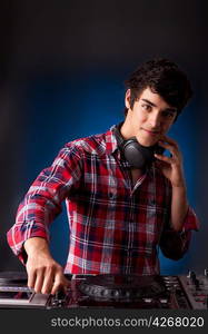 Young and handsome dj playing some music