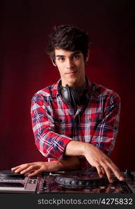 Young and handsome dj playing some music