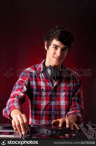 Young and handsome dj playing some music