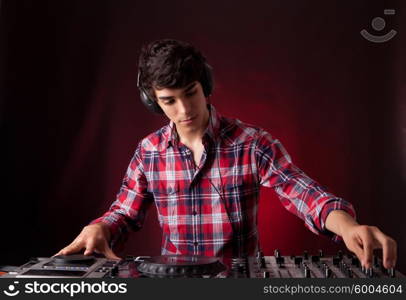 Young and handsome dj playing some music