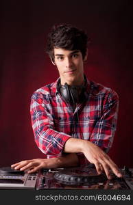 Young and handsome dj playing some music