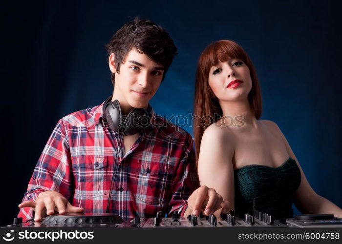 Young and handsome dj playing some music