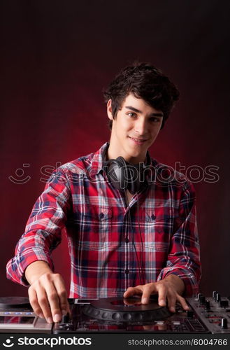 Young and handsome dj playing some music