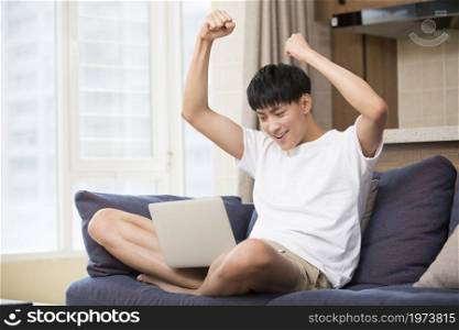 Young and handsome man cheering excitedly