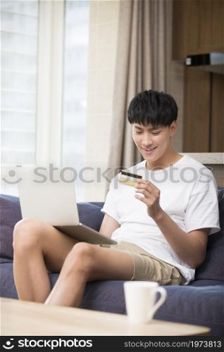 Young and handsome man shopping online