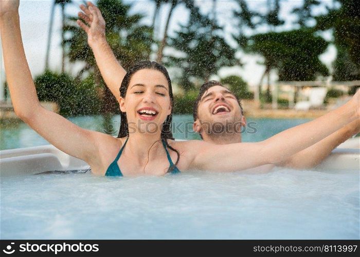 Young and happy couple inside a hot tube