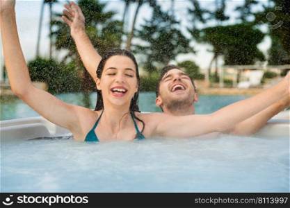 Young and happy couple inside a hot tube