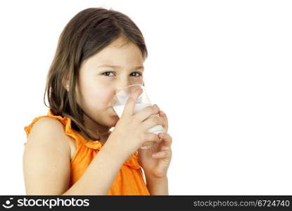 Young and healthy girl drinking a glass of milk