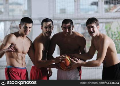 young and healthy people man have recreation and training exercise while play basketball game at sport gym indoor hall