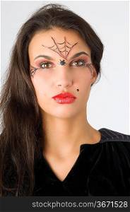 young and nice brunette with spider web painted on face