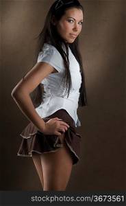 young and nice girl with white shirt and up brown short skirt