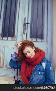 Young and pretty redhead woman wearing winter clothes