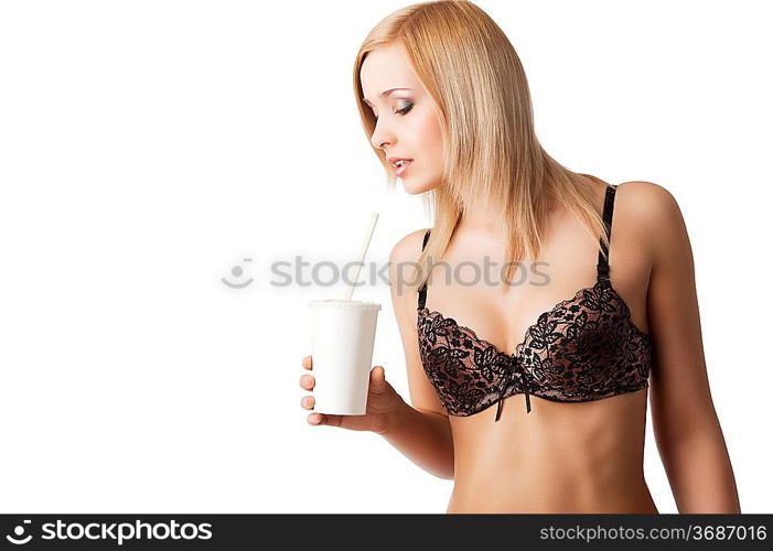 young and sexy blond girl wearing brown bra and drinking from a paper cup isolated aver white, her face is turned in profile at right and she looks in to the cup