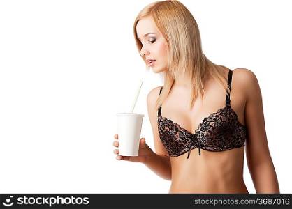 young and sexy blond girl wearing brown bra and drinking from a paper cup isolated aver white, her face is turned in profile at right and she looks in to the cup