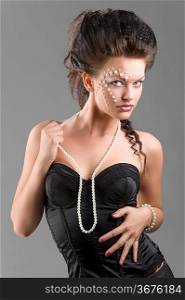 young and sexy woman in black corset with pearl necklace and perfect creative make up