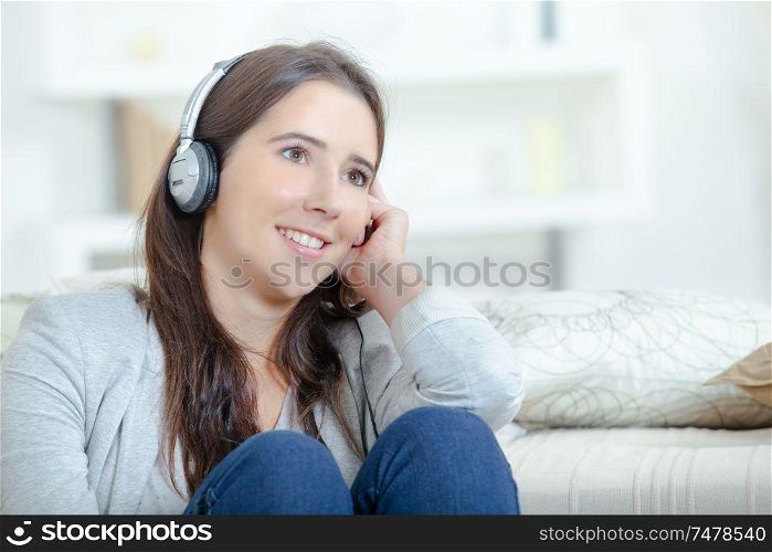 Young and smiling woman listening to music