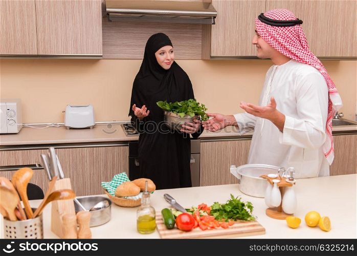 Young arab family in the kitchen