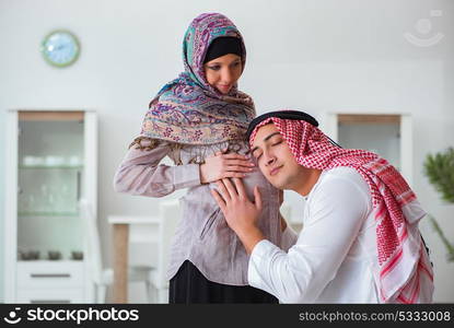 Young arab muslim family with pregnant wife expecting baby